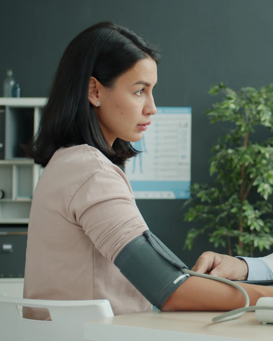 A woman has her blood pressure taken at a checkup